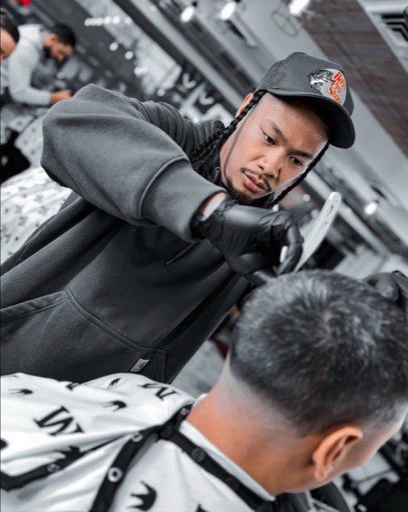 Barber at work at Empyre Barbers